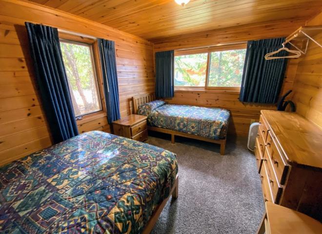 Bedroom with a full size bed and twin.