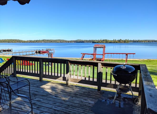 Deck area that over looks the beach and playground, also with charcoal grill.