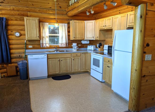 Kitchen with a refrigerator, stove, and dishwasher.