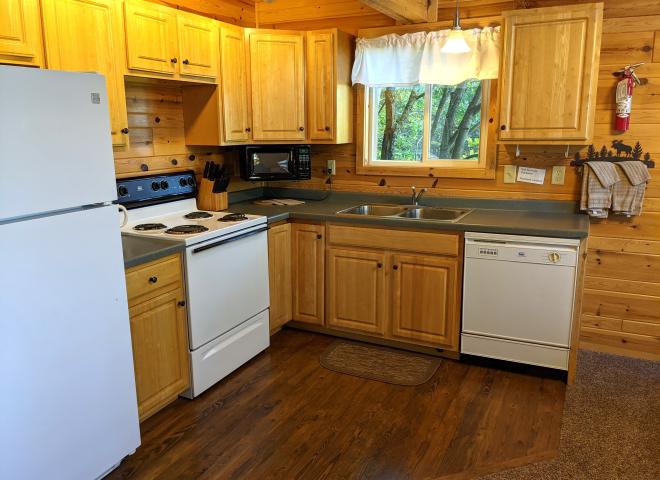 Kitchen with refrigerator, stove, and dishwasher.