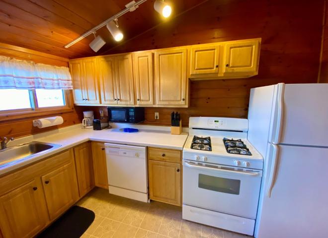Standard kitchen with refrigerator, stove, and dishwasher.