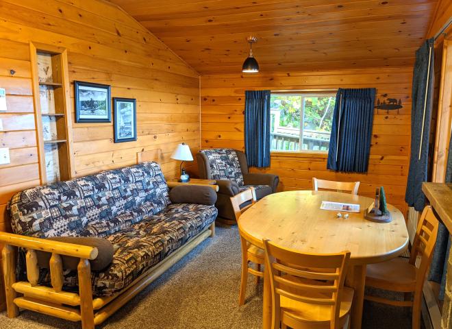 Living area with a futon, chair, and kitchen table.