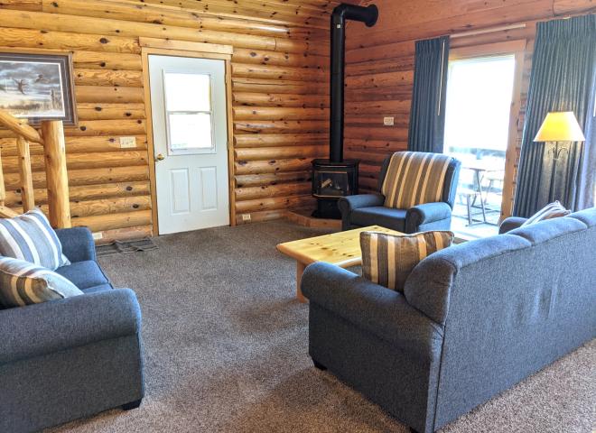 Living room with couch, loveseat, recliner, and gas fireplace.