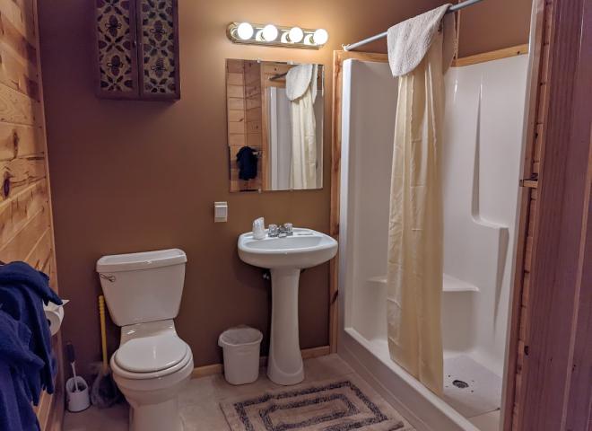 Main floor bathroom with a wide door and easy access shower and sink.