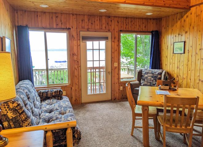 Living area with a futon, chair, and kitchen table.