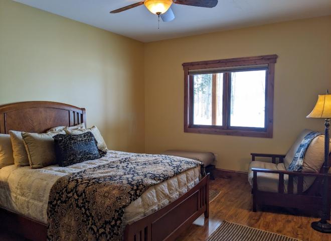 Lakeside queen bedroom with queen, XL futon, and ensuite bathroom.