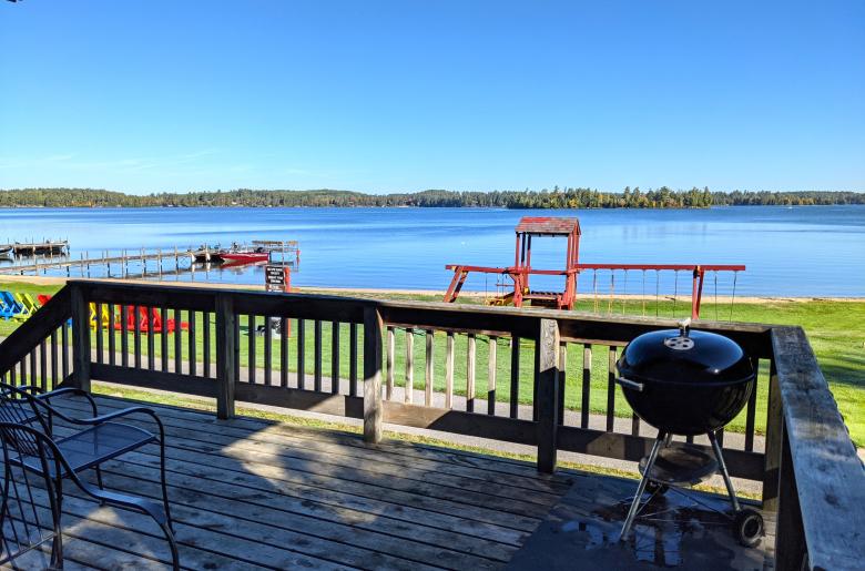 Deck area that over looks the beach and playground, also with charcoal grill.