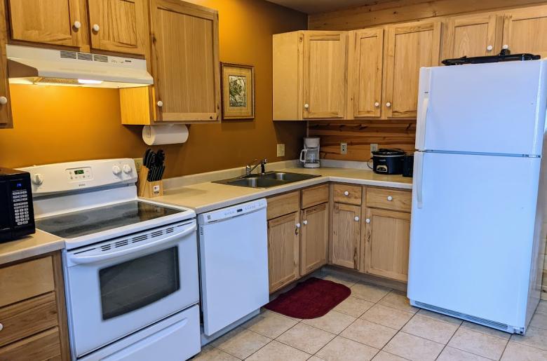 Kitchen with a refrigerator, stove, and dishwasher.