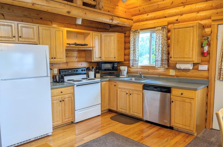 Kitchen with a refrigerator, stove, and dishwasher.