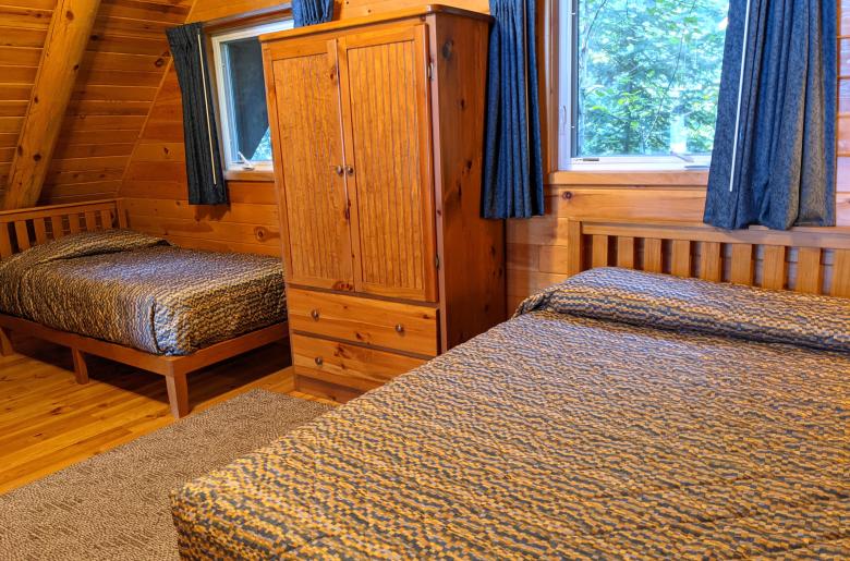 Loft bedroom with a queen and twin bed.