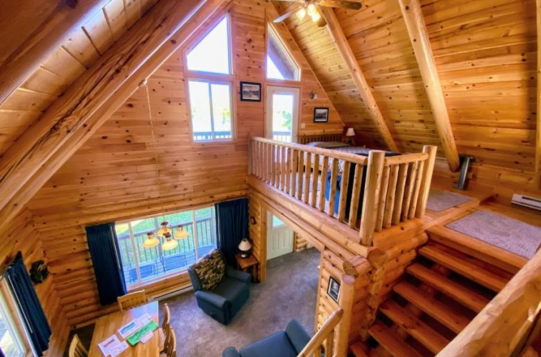 Loft bedroom with queen and door to an upper deck.