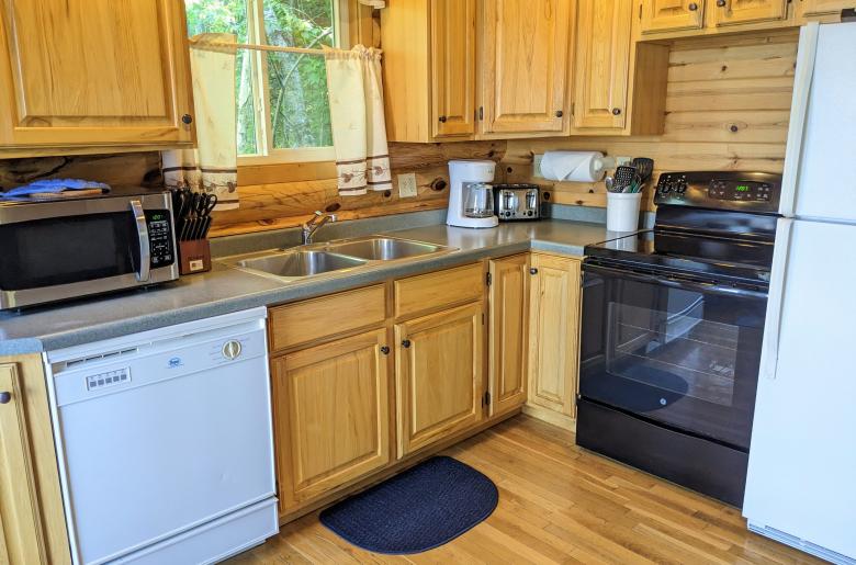 Kitchen with a refrigerator, stove, and dishwasher.