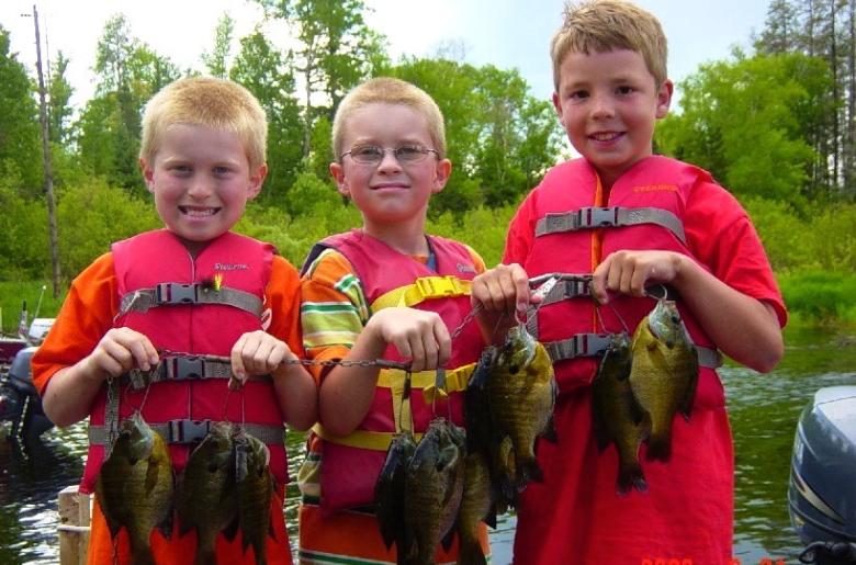 Kids holding bluegills