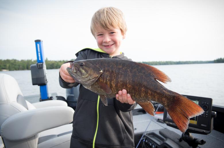 boy holding small mouth bass