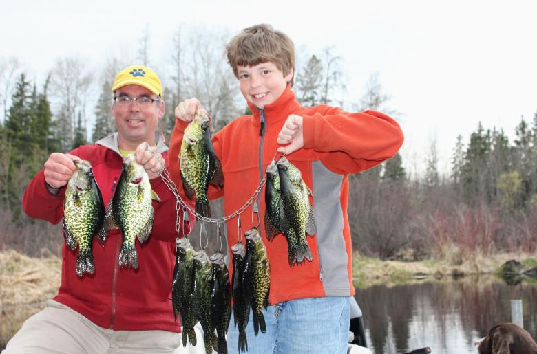 Man and son holding crappies