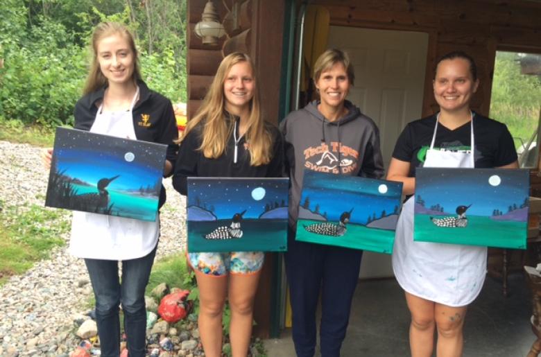 Family members participate in instructor-led painting