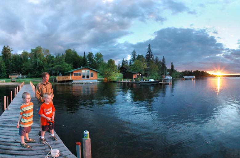 A family fishes from a dock at Pehrson Lodge
