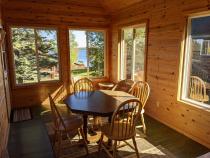 Three season porch area with seating and views of the lake.
