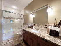Downstairs bathroom with tub/shower and granite.