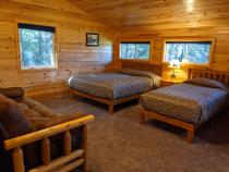 Upstairs bedroom with a queen, twin, futon, and ensuite bathroom.