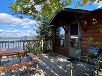 Deck area with picnic table, charcoal grill, and views of the lake.