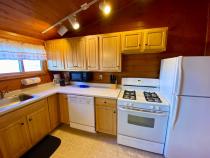 Standard kitchen with refrigerator, stove, and dishwasher.