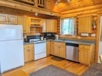 Kitchen with a refrigerator, stove, and dishwasher.