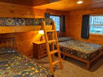 Bedroom with a full size bed, twin bed, lofted twin bed, and a ensuite bathroom.