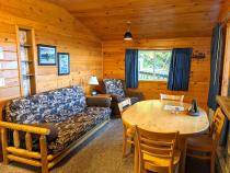 Living area with a futon, chair, and kitchen table.