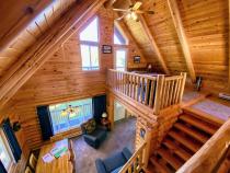 Loft bedroom with queen and door to an upper deck.