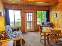 Living area with a futon, chair, and kitchen table.