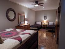 Downstairs bedroom with queen, two twins, and ensuite bathroom.