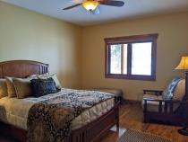 Lakeside queen bedroom with queen, XL futon, and ensuite bathroom.